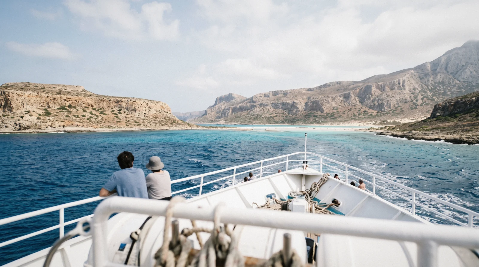 Excursion boat approaching the turquoise water of Balos Lagoon on a Balos boat trip from Kissamos, Crete