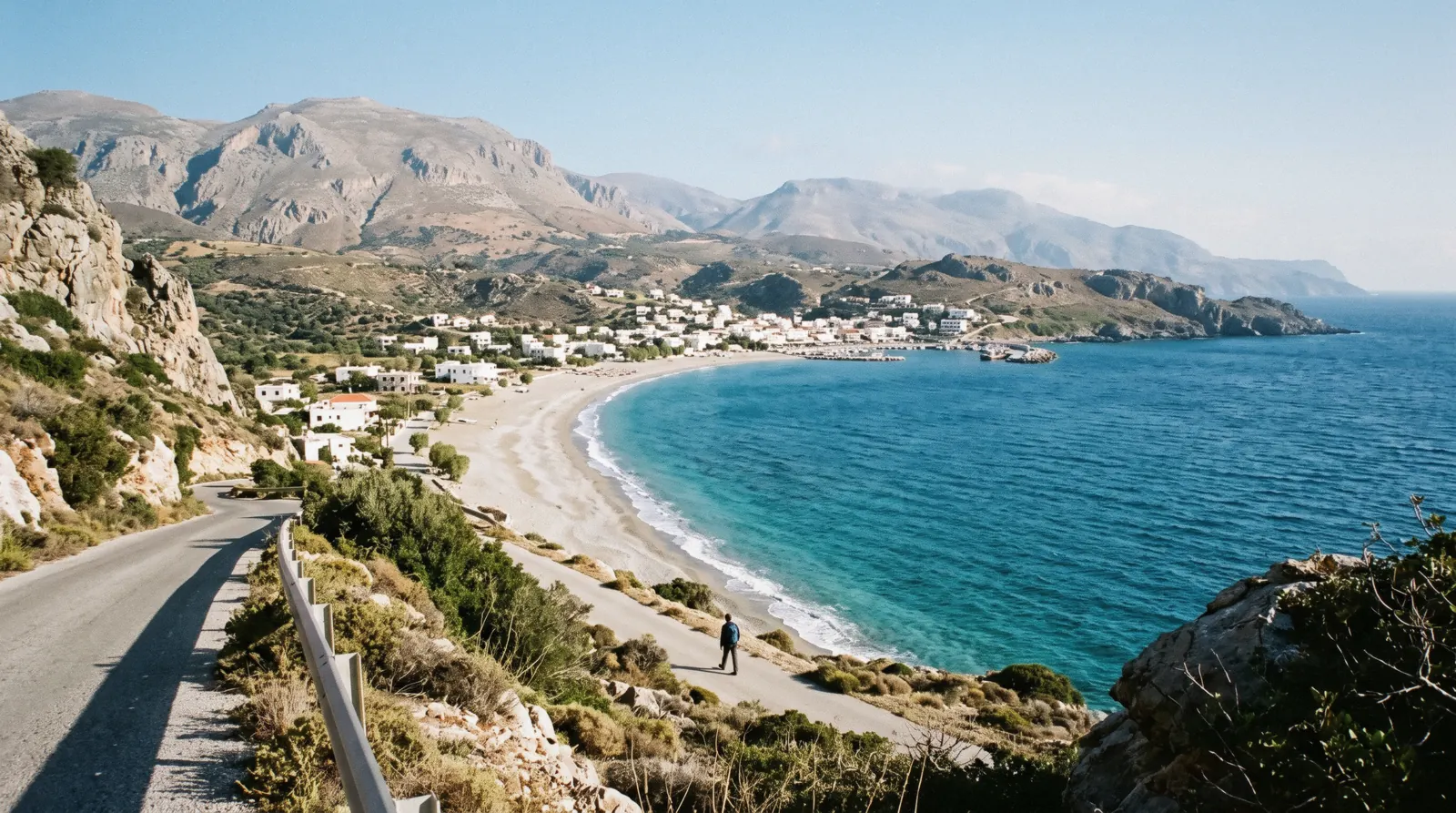 The wide sandy bay at Plakias on Crete's south coast, seen from the hillside road above the village
