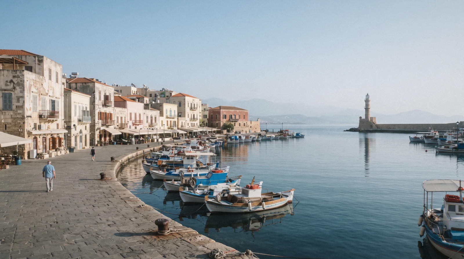 A Venetian harbour and lighthouse at sunrise on a crete travel tips planning morning
