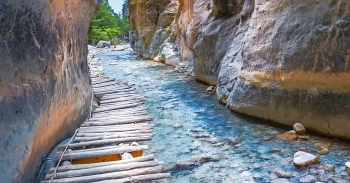 Hikers in the narrows of Samaria Gorge on an all-inclusive day from Chania, Crete Greece