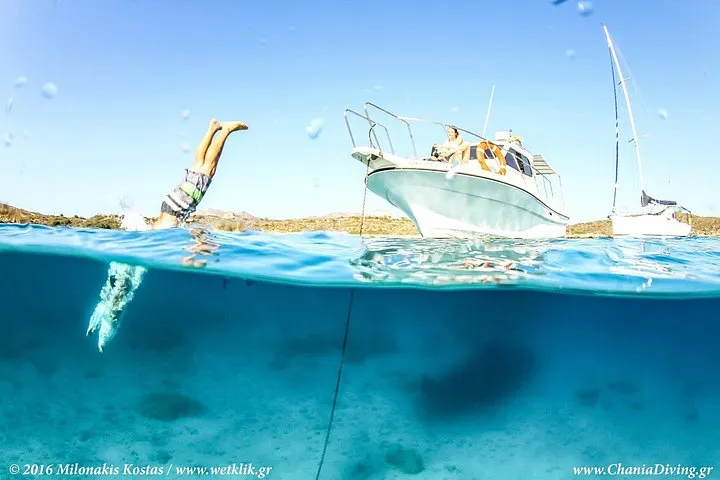 Snorkeller in clear water off the Chania coast on a boat snorkelling trip, Crete Greece