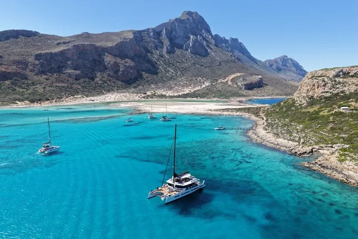 Catamaran sailing toward the Balos lagoon on a Gramvousa cruise, Crete Greece