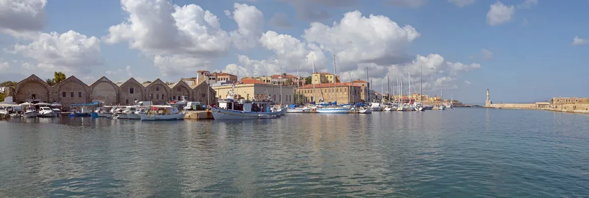 Fishing boats and the Venetian lighthouse in the old harbour of Chania, Crete