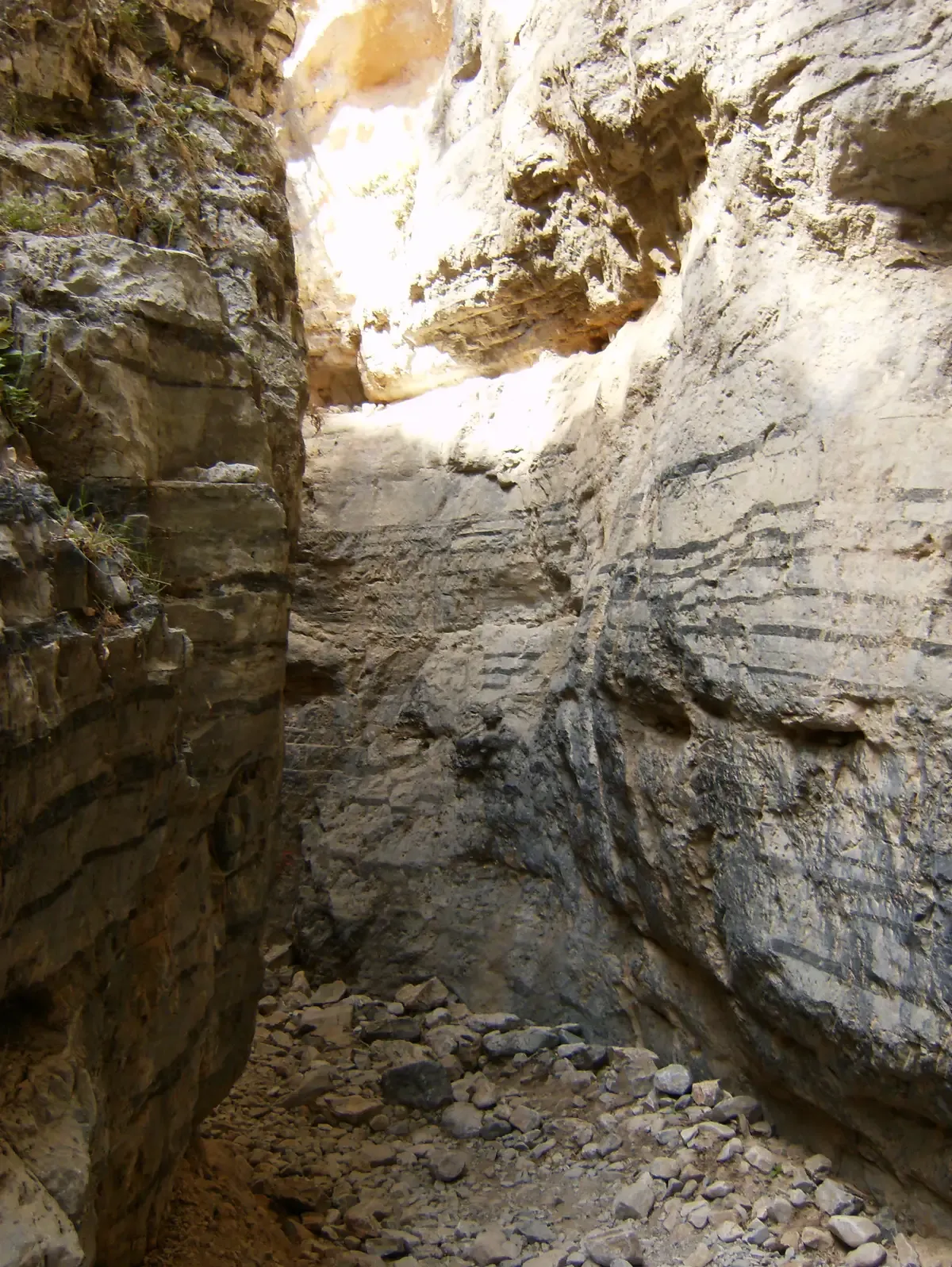The narrowest slot of Imbros Gorge where pale limestone walls close in on the hiking trail, Crete