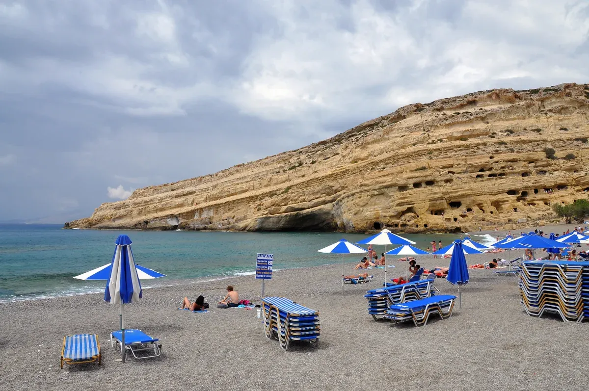 The sandstone cliff and artificial caves of Matala Bay seen from the beach, Crete