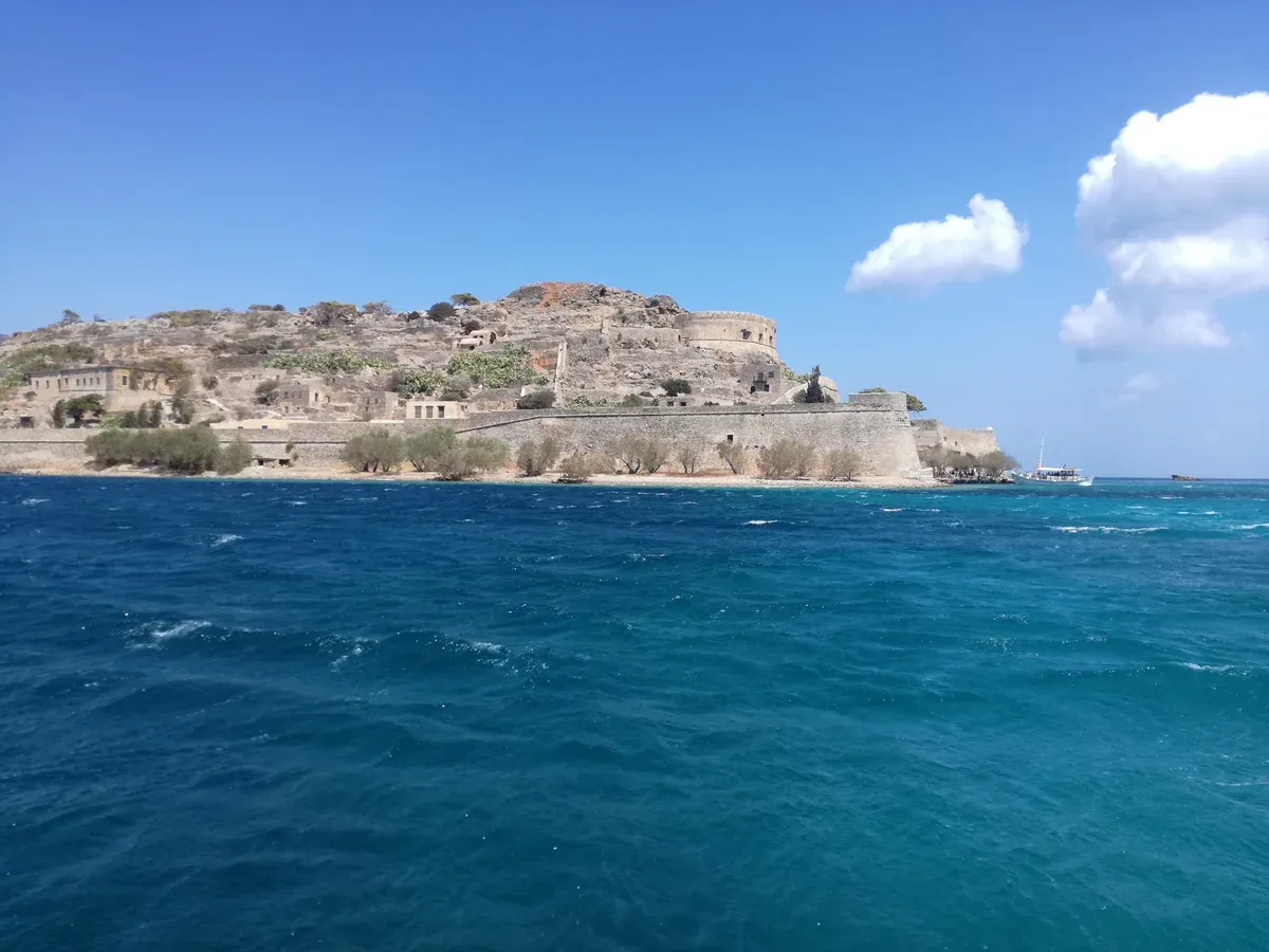 Venetian fortress walls of Spinalonga island seen from the approach boat, Crete
